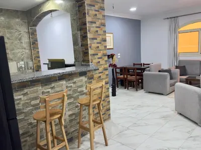 a lobby with a bar with chairs and tables at German Dolphin in Quseir