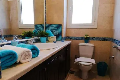 a bathroom with a sink and a toilet at Luxury 4 bedroom villa with a heated pool in Hurghada