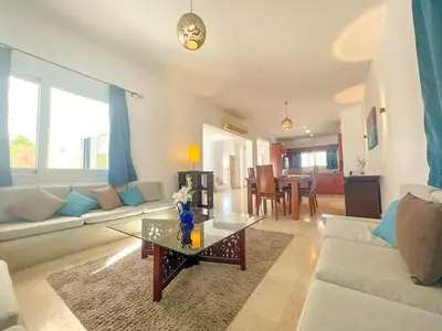 a living room with a couch and a table at Luxury 4 bedroom villa with a heated pool in Hurghada