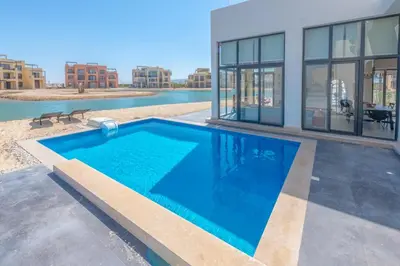 a large swimming pool in front of a building at Long Island Gouna 5BR Tawila Beach House & Pool in Hurghada