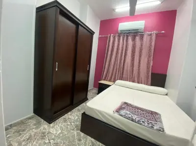 a small bedroom with a bed and a cabinet at ALRahman Building in Aswan
