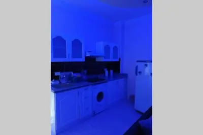 a kitchen with a sink and a white refrigerator at sheraton blaza 101 in Hurghada