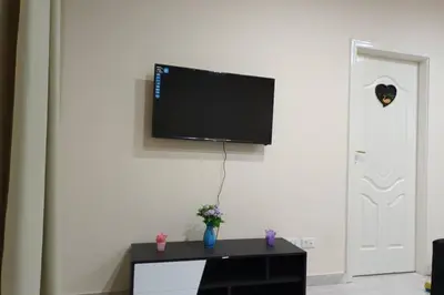 a living room with a tv on a white wall at sheraton blaza 101 in Hurghada