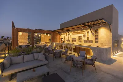 a patio with tables and chairs and a bar at Sunrise Tucana Resort Grand Select in Hurghada