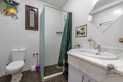 a bathroom with a sink and a toilet and a shower at Turtles Beach Resort Hurghada By VTGooo in Hurghada