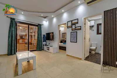 a living room with a toilet and a television at Turtles Beach Resort Hurghada By VTGooo in Hurghada