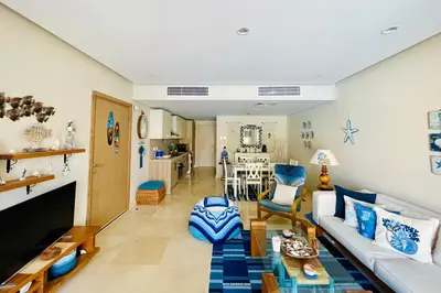 a living room with a couch and a table at Kitesurfer Shared House, Pool View & Beach Access in Hurghada