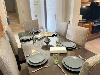 a dining room table with plates and silverware on it at Y 140 wast golf heated private pool in Hurghada