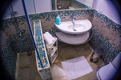 a small bathroom with a sink and a shower at NUB INN in Aswan