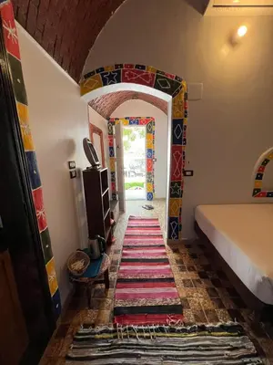 a hallway in a house with a colorful rug on the floor at Artika Wadi Kiki Hotel in Aswan