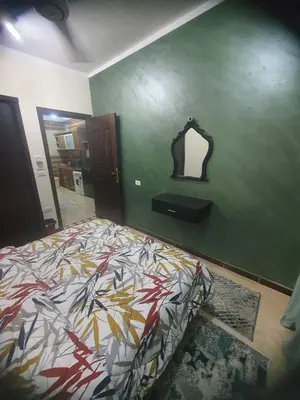 a bedroom with a bed and a mirror on the wall at Abeer suites 2 in Hurghada