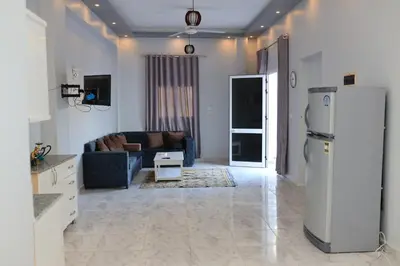a living room with a refrigerator and a couch at Nefertarie Guest House in Luxor
