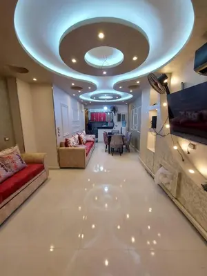 a living room with a ceiling with a couch and a table at شقة فندقية على البحر in Hurghada