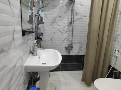 a white bathroom with a sink and a shower at 2bedroom apartment in Summer Land Beach Resort in Hurghada