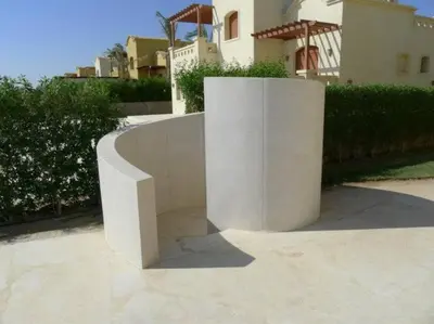 a concrete bench in front of a house at Gorgeous Villa in Gouna with Heated Private Pool in Hurghada