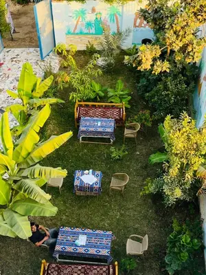 an overhead view of a garden with benches and chairs at Noby Guest House in Luxor