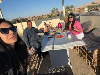 a group of people sitting at a table at Noby Guest House in Luxor