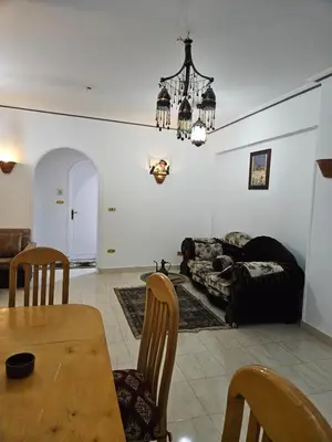 a living room with a table and a chandelier at Egypt Villa Garden in Luxor