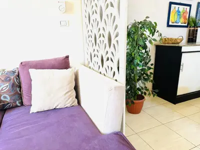 a living room with a couch and a plant at RITA HOUSE SEA VIEW. Hurghada center in Hurghada