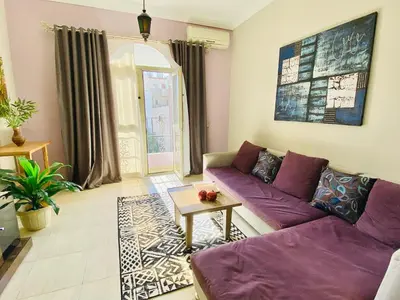 a living room with a purple couch and a table at RITA HOUSE SEA VIEW. Hurghada center in Hurghada