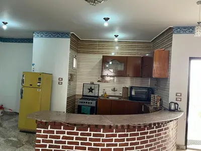 a kitchen with a brick counter in the middle at Valley Of The Kings House in Luxor