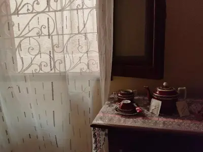 a kitchen with a window and two tea pots on a counter at Nefertari Guest House in Aswan