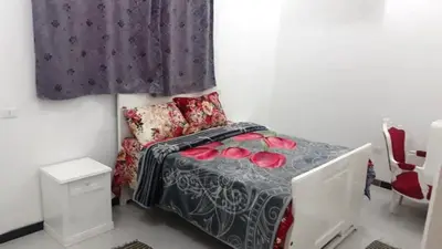 a small bedroom with a bed and a window at Bob Marley Guest House in Luxor