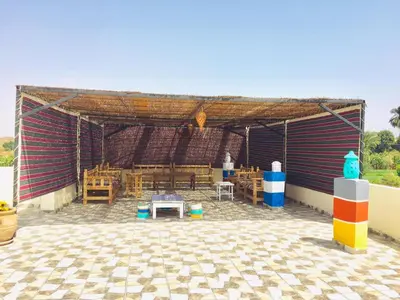 a pavilion with a table and chairs in it at Bob Marley Guest House in Luxor