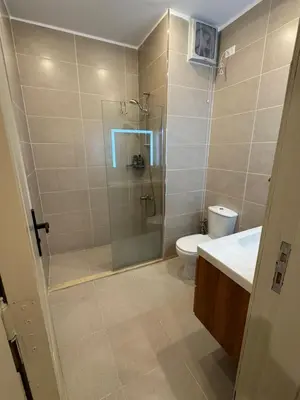 a bathroom with a shower and a toilet and a sink at Apartment with private Beach in Sahl Hasheesh in Hurghada