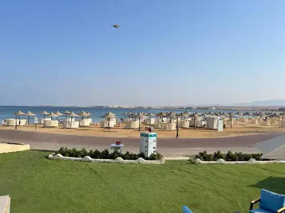a view of a beach with a bunch of huts at Apartment with private Beach in Sahl Hasheesh in Hurghada