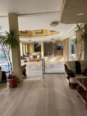 a lobby with couches and chairs in a building at Apartment with private Beach in Sahl Hasheesh in Hurghada