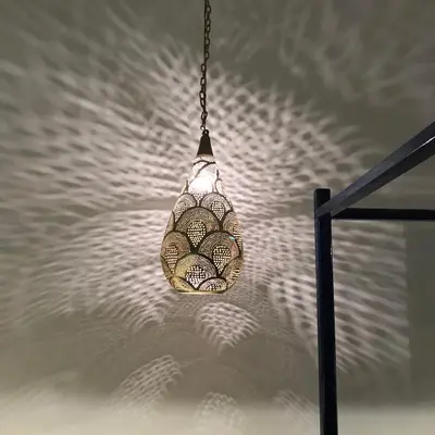 aendant light hanging from a ceiling with shadows on a wall at Luxury Ground Floor Appartment , BEST mountain views! near Temples in Luxor