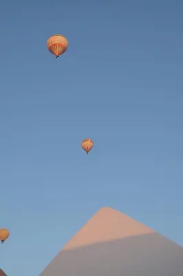 three kites flying in the sky over a pyramid at Luxury Ground Floor Appartment , BEST mountain views! near Temples in Luxor