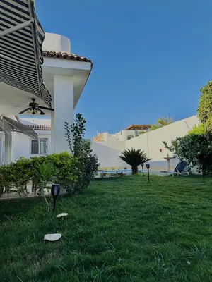 a yard with a house with a letter t on it at Luxor Rose Villa in Luxor