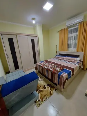 a bedroom with a bed and a couch in it at STAR HOME HURGHADA ARABIA in Hurghada