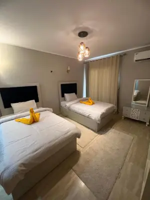 a bedroom with two beds with yellow towels on them at Villa KUBA luxury private pool Hurghada in Hurghada