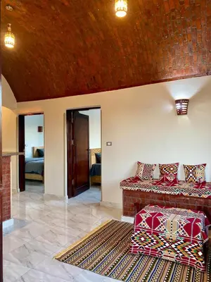 a living room with a couch and a rug at Tasneem Palace in Luxor