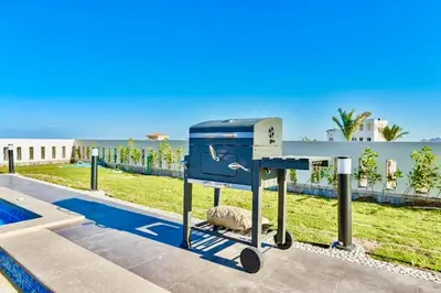 a blue recycling machine sitting next to a pool at Hurghada Sahl Hasheesh sea-view Villa with private pool in Hurghada
