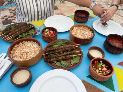 a table with plates of food and bowls of food at Lawanda Nubian B&B in Aswan