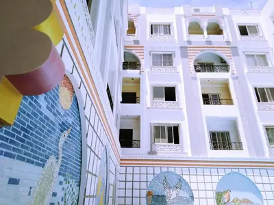 a building with a mural on the side of it at Studio pool view next to the Marina,Sheraton Plaza 320 in Hurghada