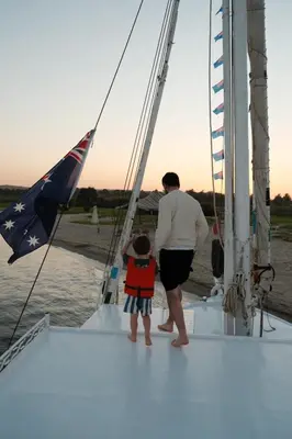 a man and a child on a sailboat at My Dream Nile Felucca in Aswan