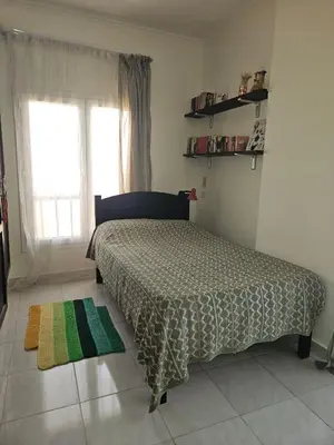 a bedroom with a bed and a window and a rug at Hurghada Village sea view in Hurghada