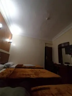 a hotel room with two beds and a mirror at New Saint Catherine Hotel in Luxor