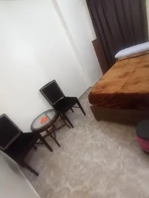 a bedroom with two chairs and a bed at New Saint Catherine Hotel in Luxor