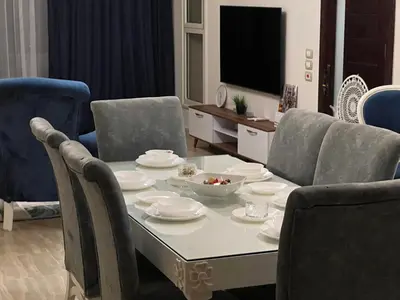 a living room with a table and chairs and a television at Villa KUBA luxury private pool 2 in Hurghada