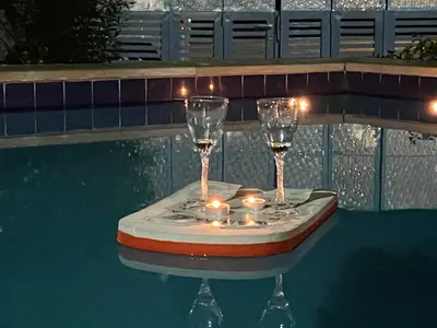 two wine glasses with candles on a table in a swimming pool at Villa KUBA luxury private pool 2 in Hurghada