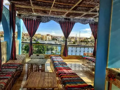 a balcony with benches and a view of a city at Nubia castle in Aswan