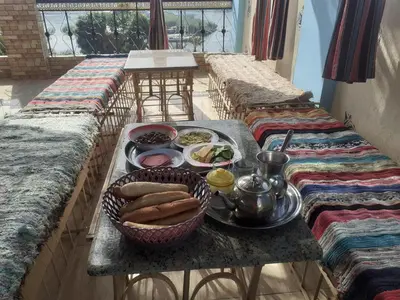 a table with a tray of food on a balcony at Nubia castle in Aswan