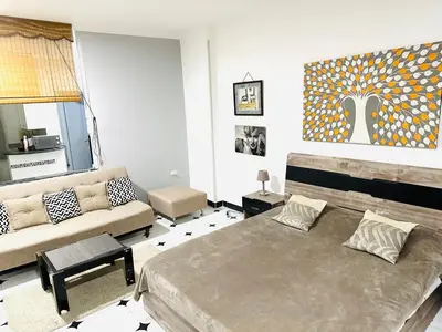 a living room with a bed and a couch at Lima Modern. Sea View. Strong Wi Fi. Sheraton Road in Hurghada