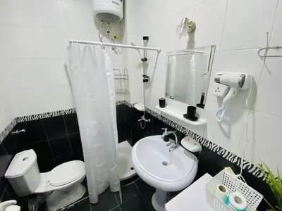 a bathroom with a white toilet and a sink at Lima Modern. Sea View. Strong Wi Fi. Sheraton Road in Hurghada